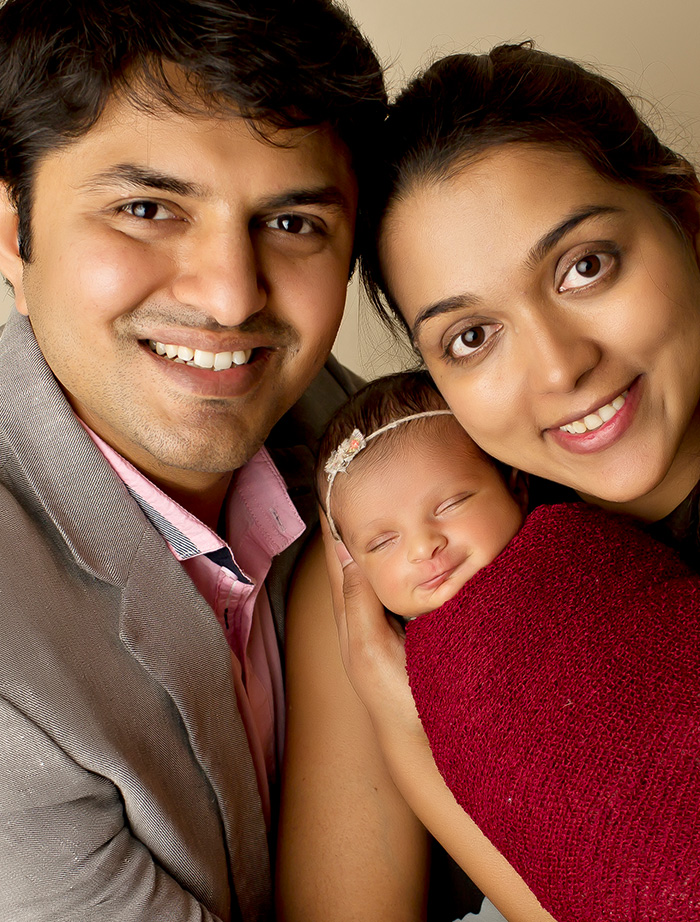 Mansfield Texas dentists Doctor Rushabh Doshi and Rini Bavishi smiling with their baby