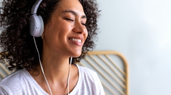 Woman smiling while wearing headphones