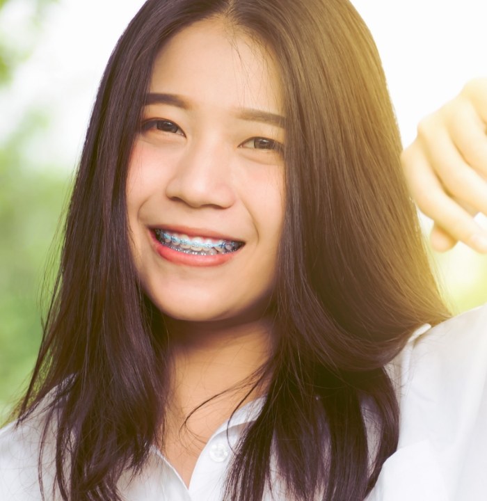 Young woman with braces smiling