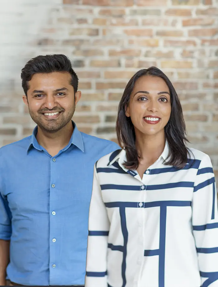 Doctor Rushabh Doshi and Rini Bavishi smiling with their baby
